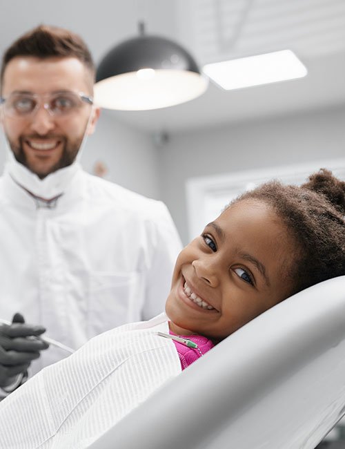 ccheerful-african-child-lying-dentist-chair-smiling