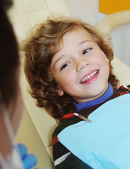 curly-haired-child-indulges-grimaces-dental-chair